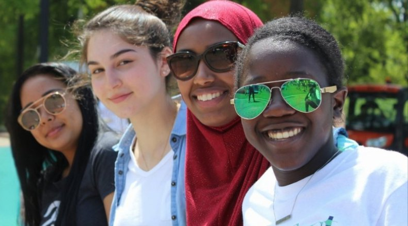 four women look at camera